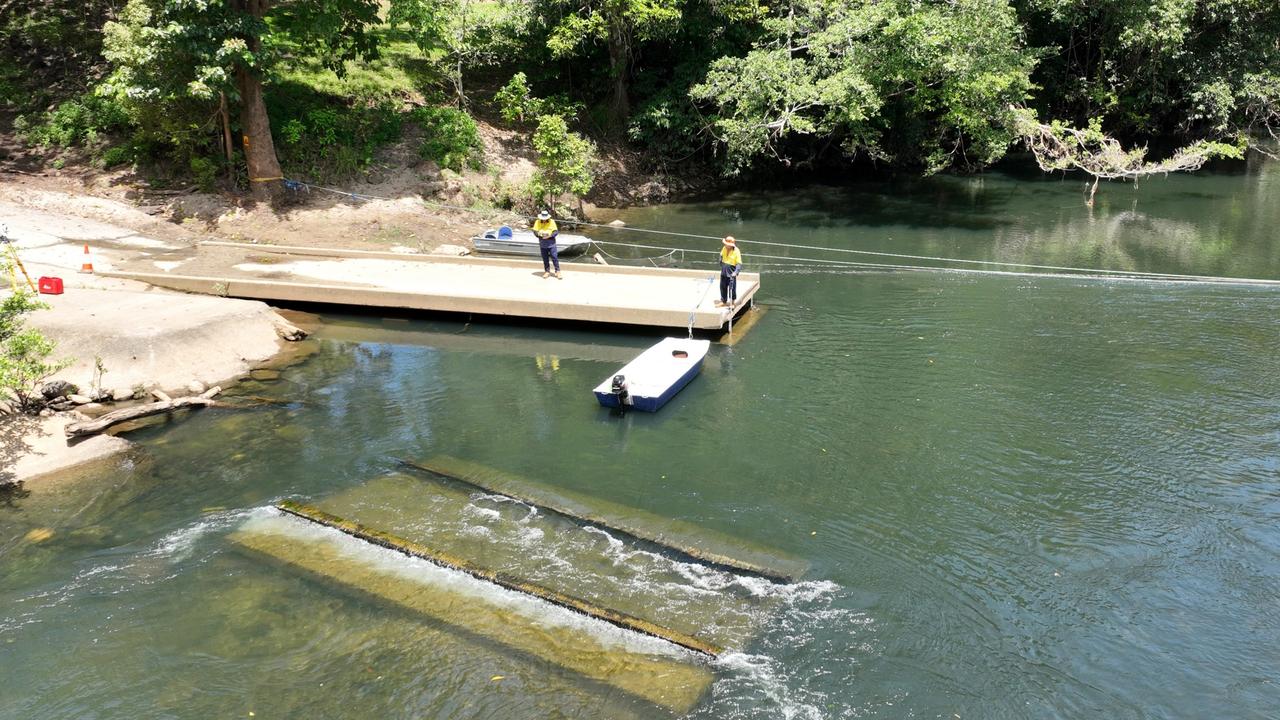 Engineers from Cairns Regional Council and Dawson's Engineering compile surveying work on the destroyed Fisheries Bridge. Picture: Brendan Radke