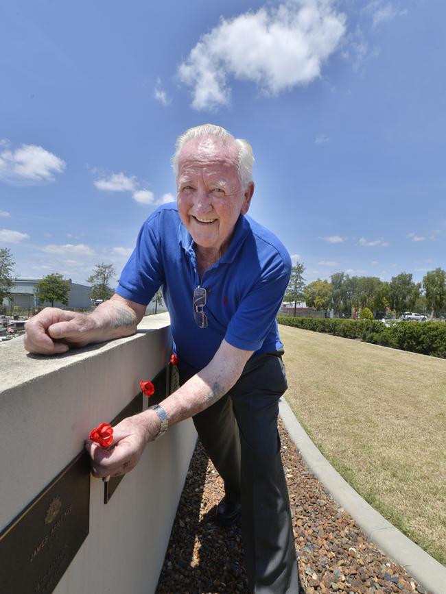 Matt Rennie laying poppies at the Ipswich Cemetery for Remembrance Day. Photo: file