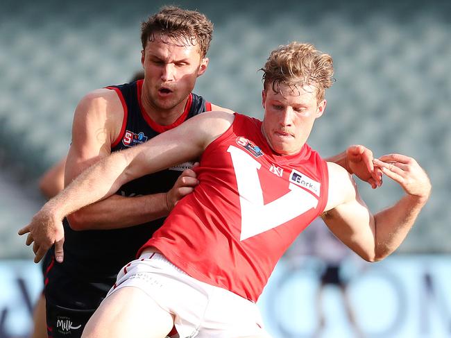 North’s Harrison Wigg battles against Norwood’s Peter Bampton Picture: Sarah Reed