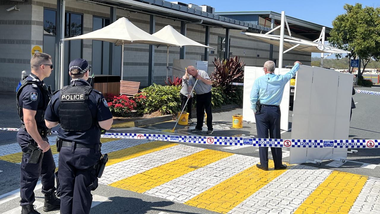 Staff seen cleaning up the scene after Mr Whenuaroa’s stabbing. Picture: Keith Woods.