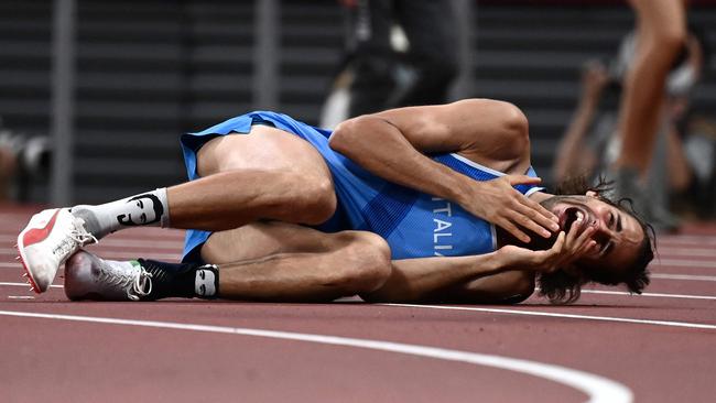 Italy's Gianmarco Tamberi reacts as he competes in the men's high jump final during the Tokyo 2020 Olympic Games at the Olympic Stadium in Tokyo on August 1, 2021. (Photo by Jewel SAMAD / AFP)