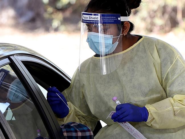 PERTH, AUSTRALIA - MAY 03: A health worker carries out COVID-19 testing at the Joondalup drive-through clinic on May 03, 2021 in Perth, Australia. Perth is on alert after a hotel quarantine security guard from the Pan Pacific hotel and two of his housemates tested positive for COVID-19 on the weekend. While WA Premier Mark McGowan has not imposed a lockdown in response to the recent cases, restrictions requiring the use of face masks outdoors have been reintroduced. (Photo by Paul Kane/Getty Images)