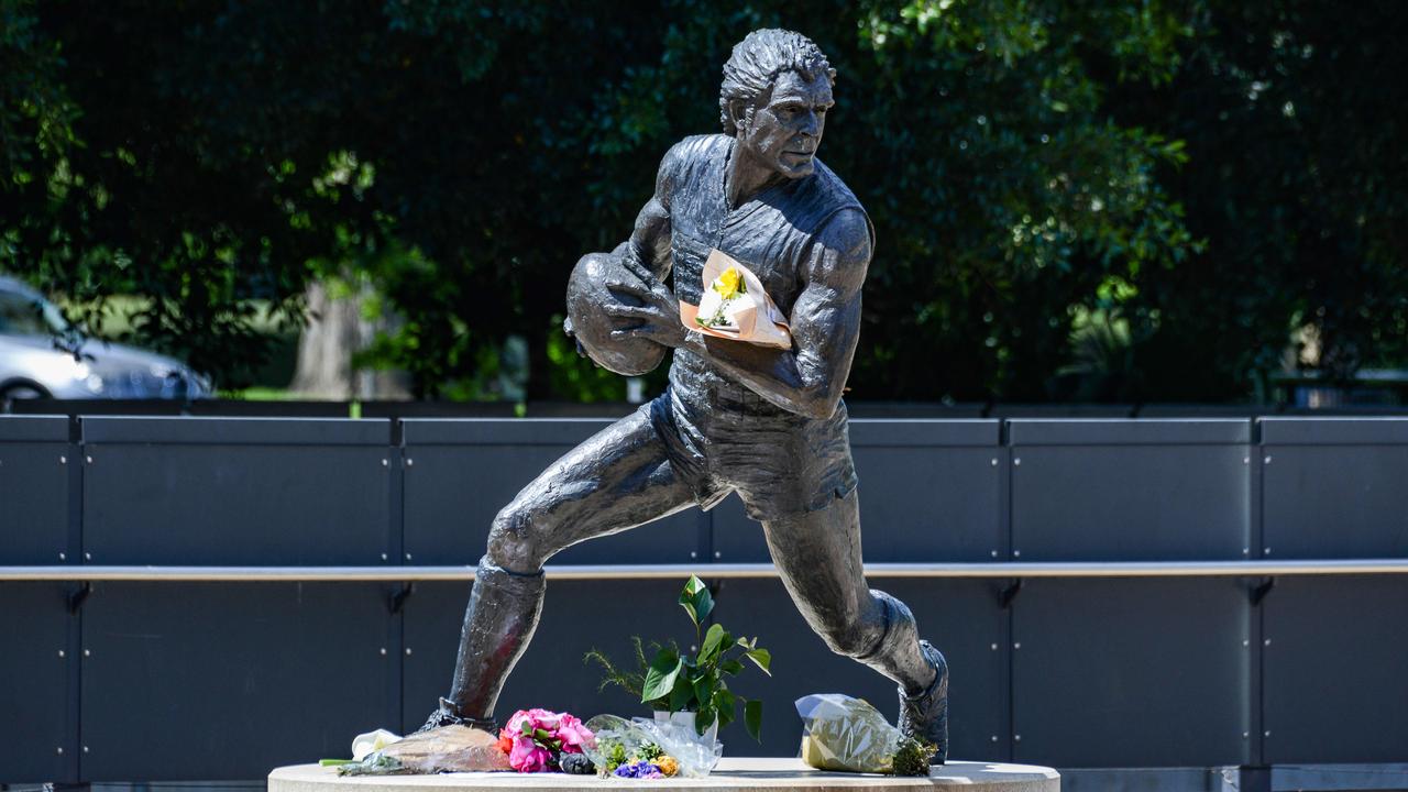 Floral tributes at the Russell Ebert statue at Adelaide Oval. Picture: Brenton Edwards