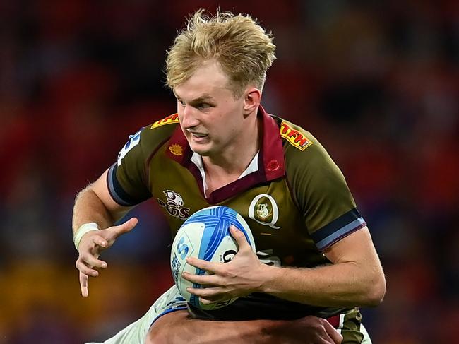 BRISBANE, AUSTRALIA - APRIL 27: Tom Lynagh of the Reds is tackled by Anton Segner of the Blues during the round 10 Super Rugby Pacific match between Queensland Reds and Blues at Suncorp Stadium, on April 27, 2024, in Brisbane, Australia. (Photo by Albert Perez/Getty Images)