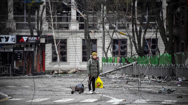 A young man walks in a street of Mariupol on April 12 as Russian troops intensified a campaign to take the strategic port city.