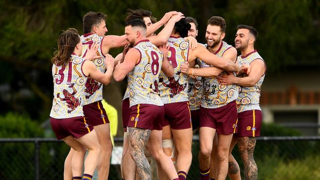 Steve Tolongs of Murrumbeena is congratulated by teammates after kicking a goal. (Photo by Josh Chadwick)