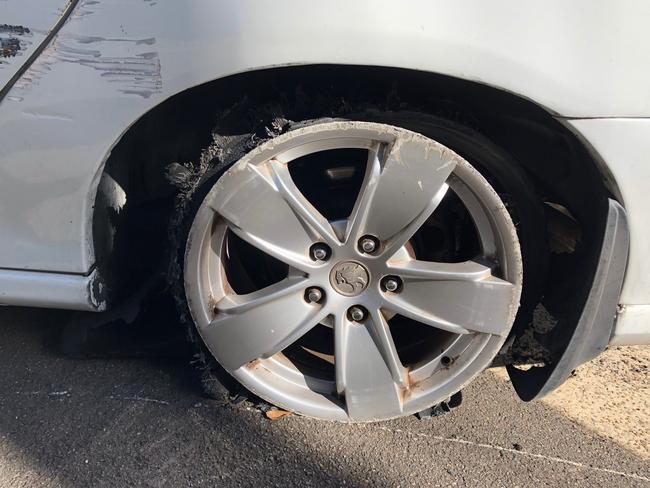 A shredded tyre and damaged wheel on a Holden Commodore abandoned in Quirk Rd, Manly Vale, after an alleged police pursuit. Picture: Jim O'Rourke