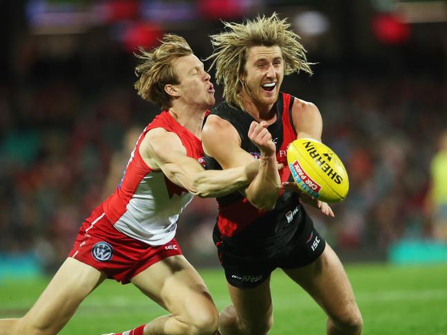 Essendon's Dyson Heppell handballs ahead of Sydney's Callum Mills during AFL match Sydney Swans v Essendon Bombers at the SCG. Picture. Phil Hillyard