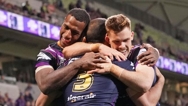 Will Chambers of the Melbourne Storm is congratulated by Suliasi Vunivalu of the Melbourne Storm and Ryan Papenhuyzen of the Melbourne Storm after scoring a try during the Round 25 NRL match between the Melbourne Storm and the North Queensland Cowboys at AAMI Park in Melbourne, Friday, September 6, 2019. (AAP Image/Scott Barbour) NO ARCHIVING, EDITORIAL USE ONLY