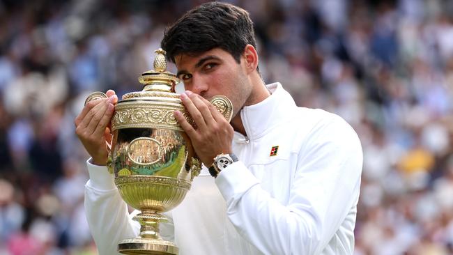 Carlos Alcaraz of Spain kisses the trophy following victory against Novak Djokovic of Serbia in the gentlemen's singles final during day 14 of The Championships Wimbledon 2024 in London. Picture: Clive Brunskill/Getty Images