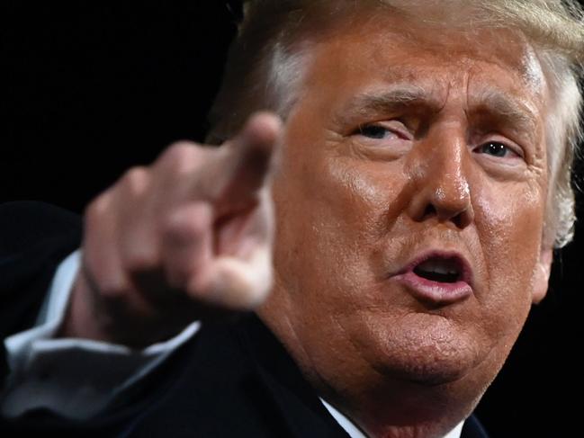 US President Donald Trump points at the end of a rally to support Republican Senate candidates at Valdosta Regional Airport in Valdosta, Georgia on December 5, 2020. - President Donald Trump ventures out of Washington on Saturday for his first political appearance since his election defeat to Joe Biden, campaigning in Georgia where two run-off races will decide the fate of the US Senate. (Photo by Andrew CABALLERO-REYNOLDS / AFP)