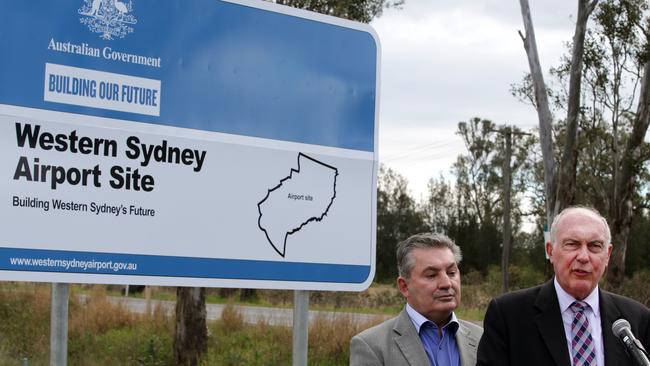 Warren Truss (right) and Russell Matheson declaring Badgerys Creek at the official site for Western Sydney Airport, in August 2015. Picture: Jonathan Ng