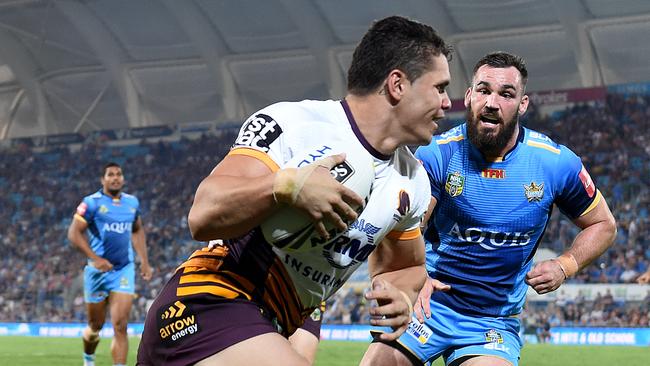 Broncos player James Roberts crosses over to score a try during the Round 5 NRL match between the Gold Coast Titans and the Brisbane Broncos at CBUS Stadium on the Gold Coast, Friday, April 1, 2016. (AAP Image/Dave Hunt) NO ARCHIVING, EDITORIAL USE ONLY