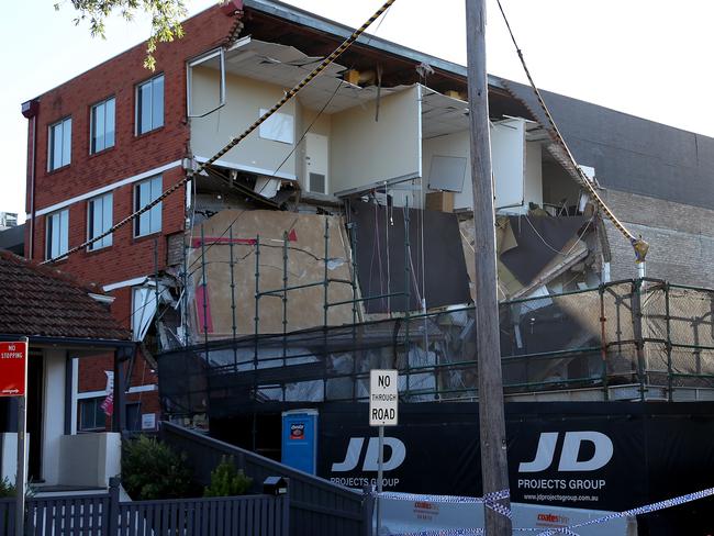 A section of an office building has collapsed in Crows Nest on the corner of Alexander and Devonshire Streets leaving a side of the structure exposed. Office workers escaped minutes before it happened after alarm bells were raised by a worker inside when they noticed a meter wide crack in the rear of the interior wall. Picture: Toby Zerna