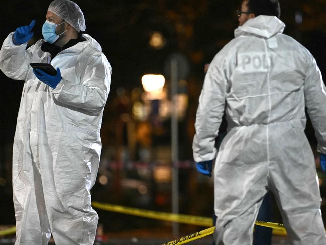 French forensic police work on the site of a knife attack where a man is suspected of killing one person and seriously wounding two police officers in Mulhouse, eastern France on February 22, 2025. Prosecutors said three more officers were lightly wounded in the attack in the city of Mulhouse, carried out by a 37-year-old suspect who is on a terror prevention watchlist, prosecutor told AFP. (Photo by SEBASTIEN BOZON / AFP)