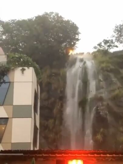 Heavy rain across Brisbane and the southeast this week created an inner-city waterfall on the cliffs above Felons Brewing and Howard Smith Wharves. Credit: Kuyen Lewis.