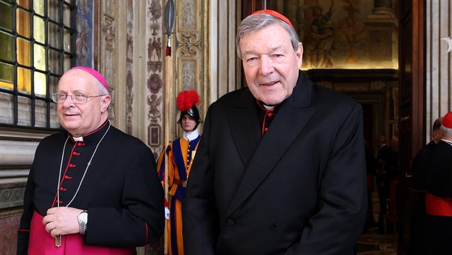 Cardinal George Pell (right) will go from life at the Vatican to jail after being found guilty of child abuse. Picture: Franco Origlia/Getty