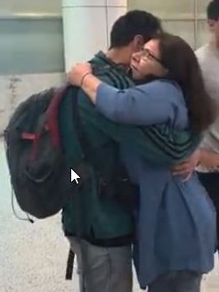 People embrace after Qatar’s mercy flight landed in Sydney. Picture: Madeleine Bower