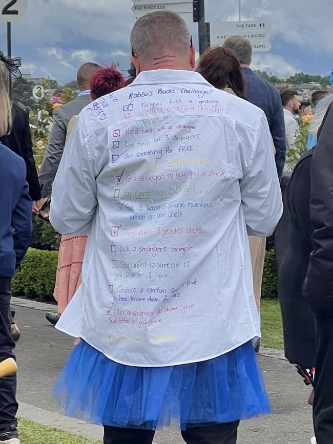 This man had a bucks challenge list scrawled on his shirt. Picture: news.com.au