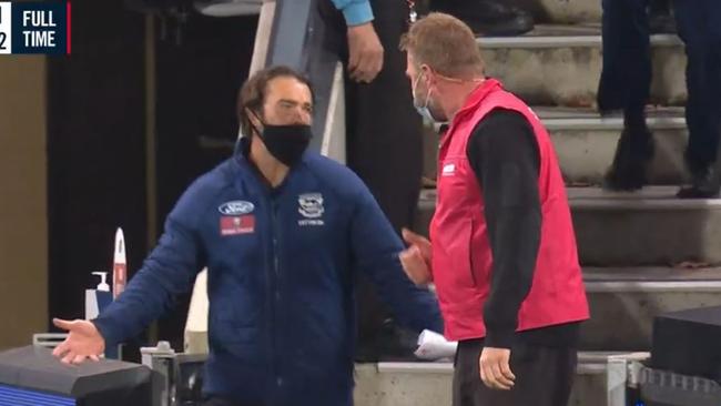 Chris Scott gestures to a security guard at three-quarter time after being tripped. Picture: Fox Footy