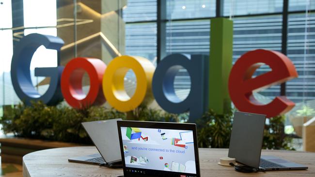 Google Inc. Chromebook laptop computers sit on display in front of a sign featuring the company's logo. Picture: Ore Huiying/Bloomberg