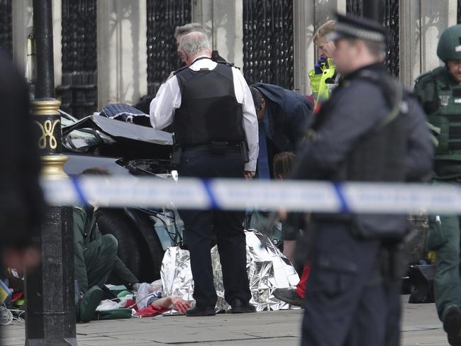 Emergency personnel tend to an injured person near the Palace of Westminster in London. Picture: Yui Mok/PA via AP