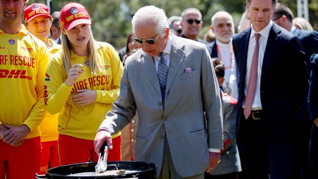 King Charles tends to the sausages at a community barbecue in Parramatta in Sydney’s west on Tuesday, watched by NSW Premier Chris Minns. Picture: NewsWire / Nikki Short