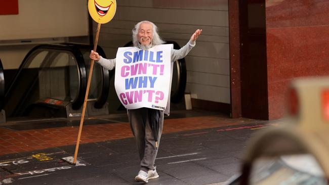 Sydney activist Danny Lim pictured in Sydney CBD in mid-2022, wearing the same sandwich board as during the arrest. Picture: Damian Shaw