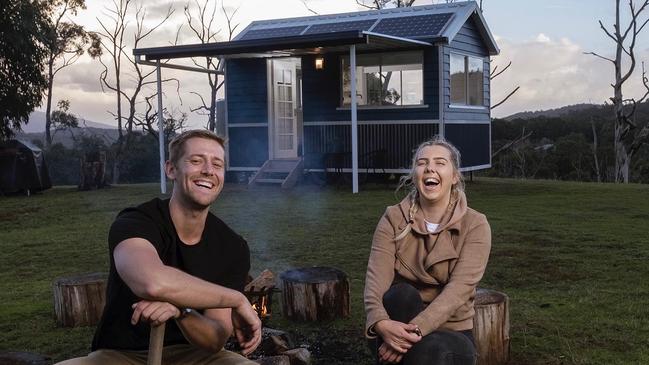 Plumber Aimee Stanton with her brother and business partner Ben outside one of the tiny houses they have built.