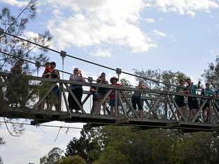 Laidley residents watch from the Nada Lagoon bridge as helicopters fill up with water to battle the Laidley fires. Picture: Ebony Graveur