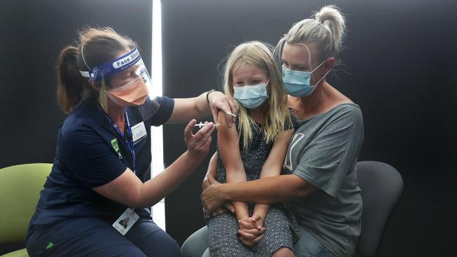 Ruby Smith 8 of New Norfolk getting her vaccination with mum Tanya Smith and with team leader nurse Leah Willis. Covid vaccinations for 5-11 year old children with one of the first clinics at Bridgewater. Picture: Nikki Davis-Jones