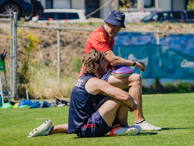 Burgess imparts some wisdom to Crow Luke Pedlar. Picture: Adelaide Football Club