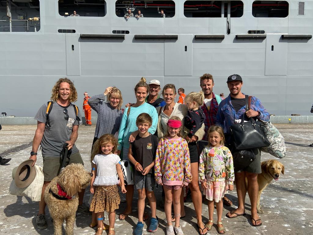 Tom Haigh and his family, with HMAS Choules in the background.