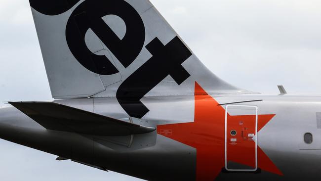 SYDNEY, AUSTRALIA - JANUARY 20: The Jetstar logo displayed on an aircraft tail at Sydney Airport  on January 20, 2024 in Sydney, Australia. Transport Minister Catherine King signed off on a deal that will allow Turkish Airlines to start serving the Australian market, rising to 35 flights a week by 2025. The decision came as the government was under mounting criticism from many for a perception that it was protecting the profits of Qantas and stymying competition in the market by limiting additional capacity for other carriers, such as Qatar Airways. (Photo by Jenny Evans/Getty Images)