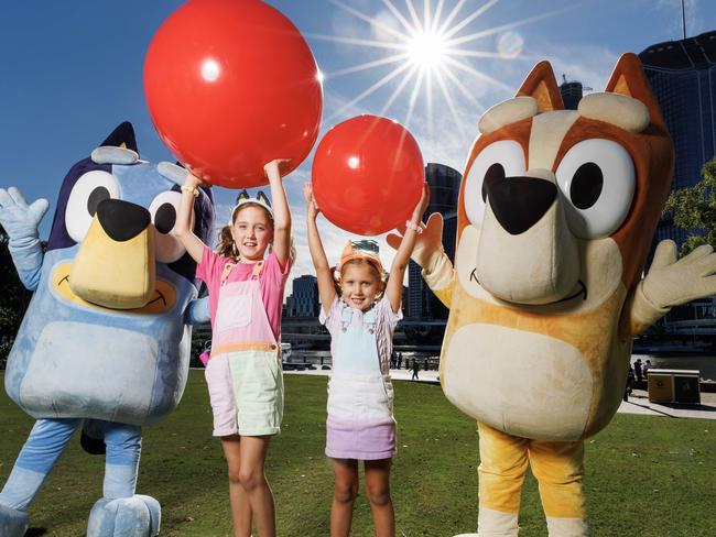 Sister Jasmine 7, and Lilah Johnstone 5, with Bluey and Bingo after taking part in the Bluey world record attempt for the biggest game of Keep Uppy at Southbank on Sunday morning. Picture Lachie Millard