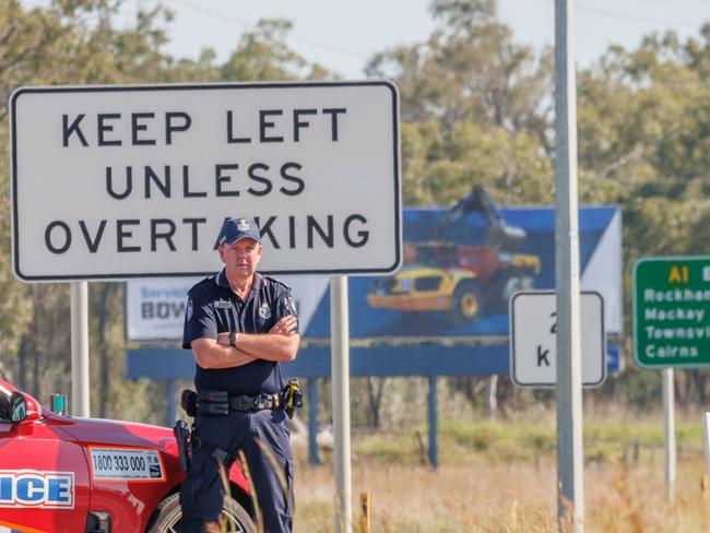 HOLDING FOR THE COURIER MAIL -  Senior Sergeant Ewan Findlater of the Queensland Police Service based in Rockhampton pictured on the Bruce Highway at Midgee.