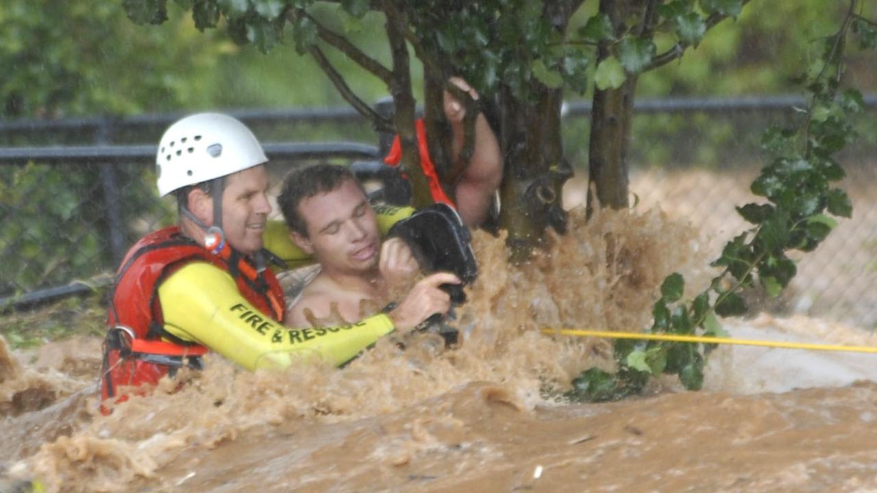 Edward Spark rescued from flooded Dent St by QFRS swift water specialist David Crichton during Toowoomba floods. Photo Nev Madsen / The Chronicle