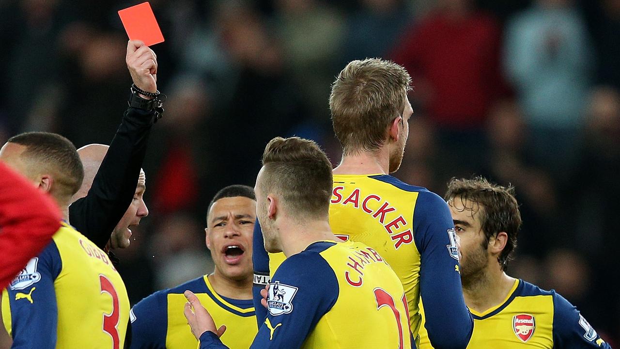 STOKE ON TRENT, ENGLAND - DECEMBER 06: Calum Chambers of Arsenal is shown a red card by Referee Anthony Taylor during the Barclays Premier League match between Stoke City and Arsenal at the Britannia Stadium on December 6, 2014 in Stoke on Trent, England. (Photo by Clive Mason/Getty Images)