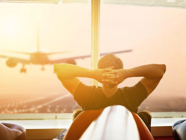 ESCAPE:  man relaxing at the airport waiting for his plane  Picture: Istock