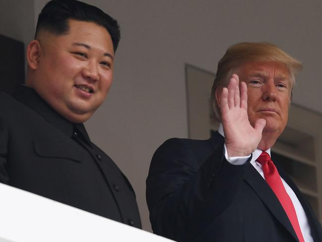 Trump and Kim look on from a veranda during their historic US-North Korea summit. Picture: AFP/Saul Loeb