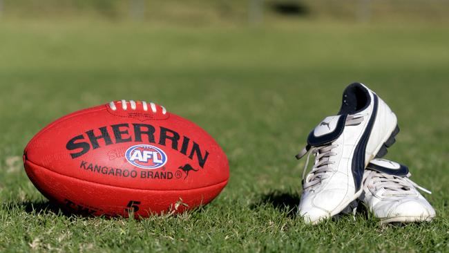 Generic AFL Sherrin football and football boots. sport /