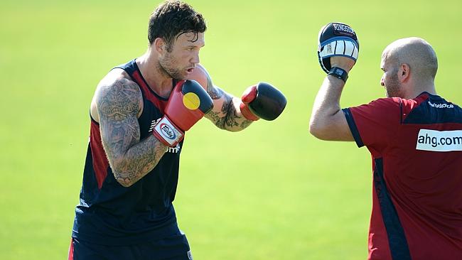 Mitch Clark (left) does some boxing while his teammates hit the track.