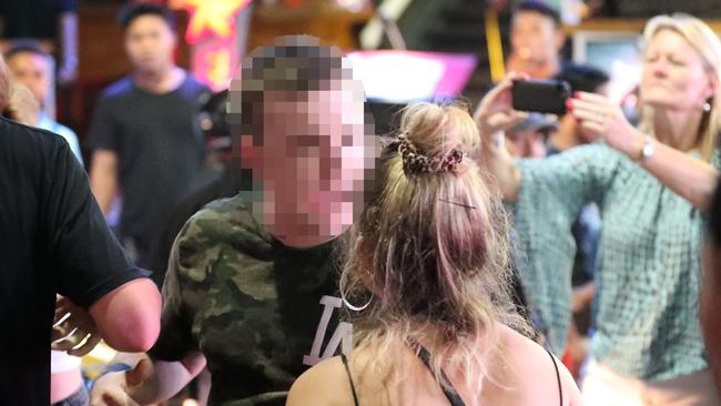 A young Australian man and woman yelling in the street in Kuta during the schoolies period. Picture: Liam Kidston.