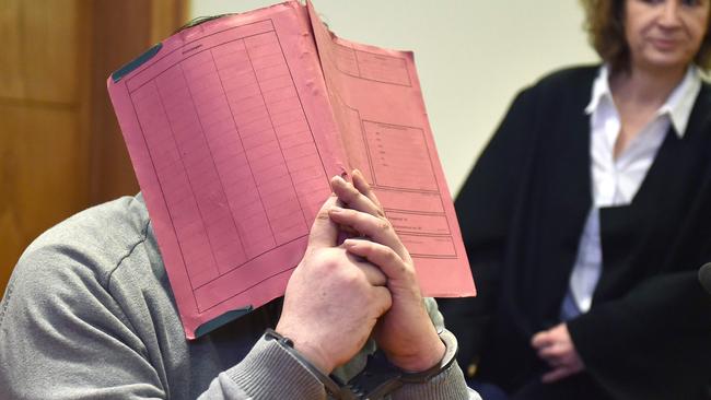 Niels Hoegel hides his face during a court hearing in 2015. Picture: AFP