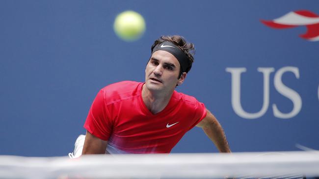 Roger Federer serves to Mikhail Youzhny during their second round match.