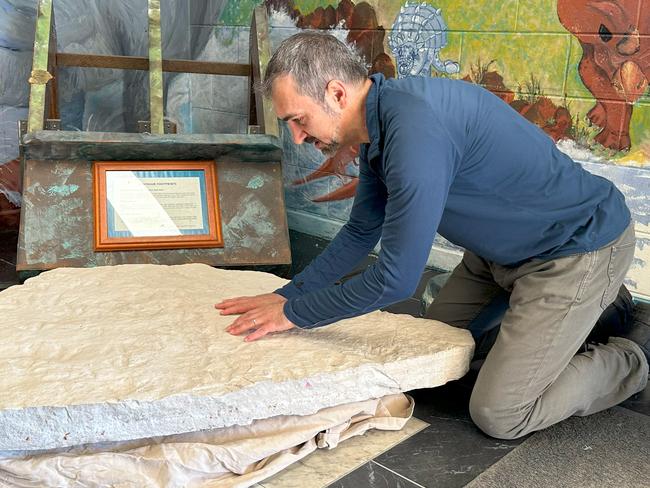 Dr Anthony Romilio - a University of Queensland researcher has confirmed a boulder at a regional school contains one of the highest concentrations of dinosaur footprints per square metre ever documented in Australia. Dr Anthony Romilio brushes Specimen at Biloela State High School.