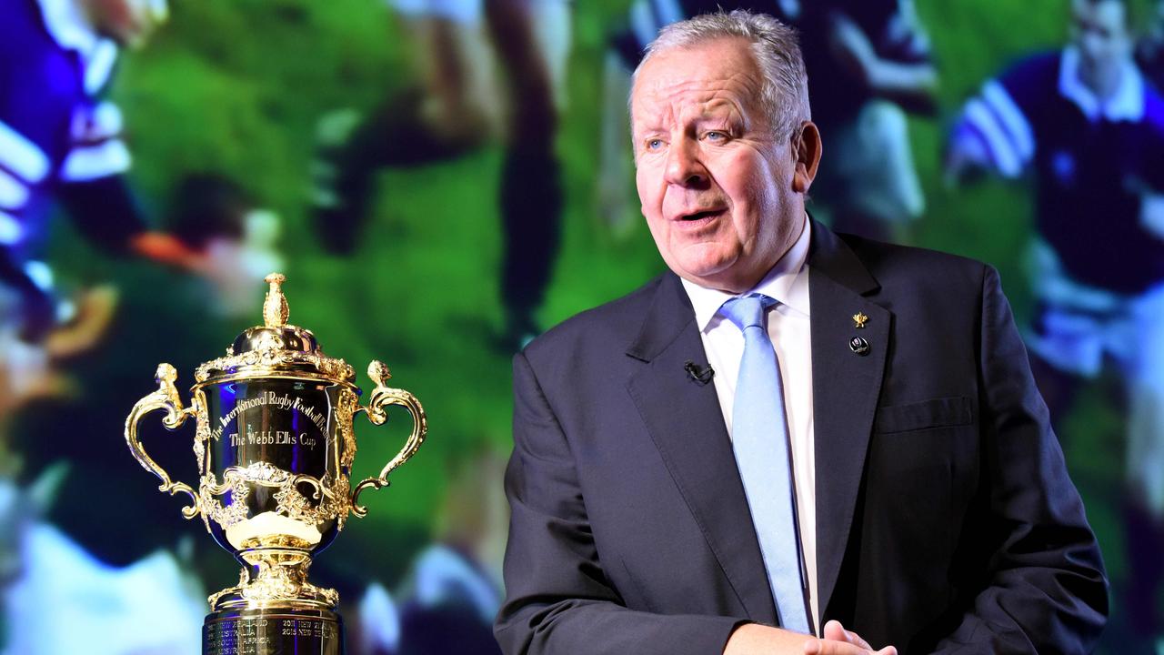World Rugby chairman Bill Beaumont speaks beside the Webb Ellis Cup.