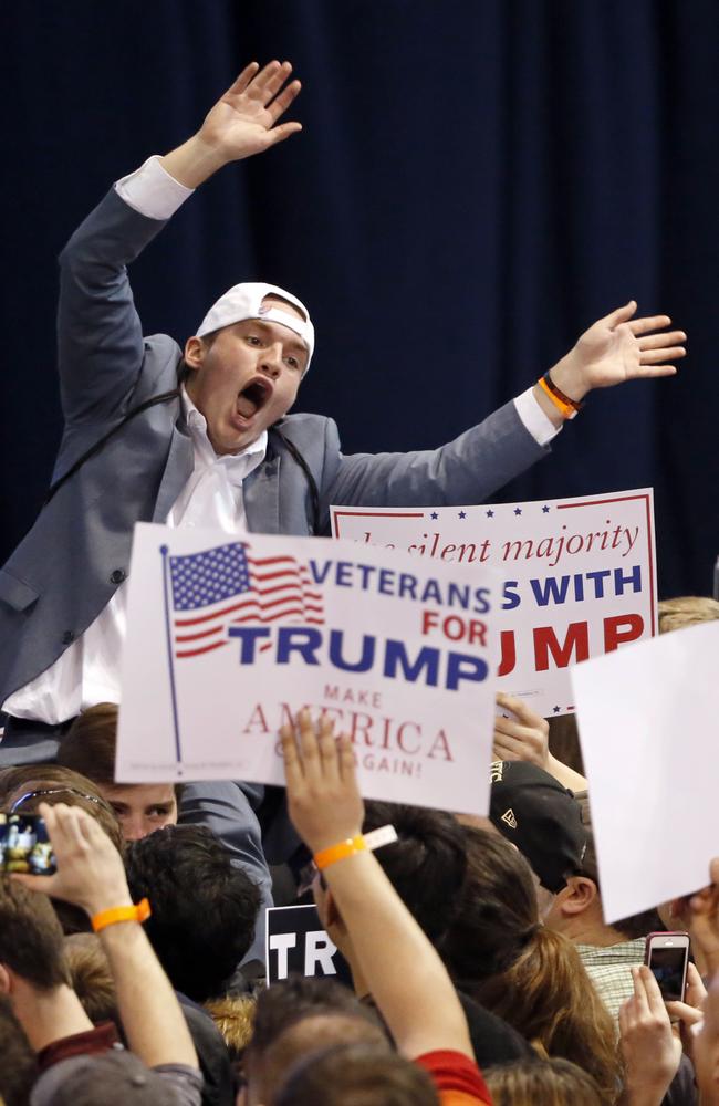 A Trump supporter tries to pump up the crowd before the rally was cancelled in Chicago.