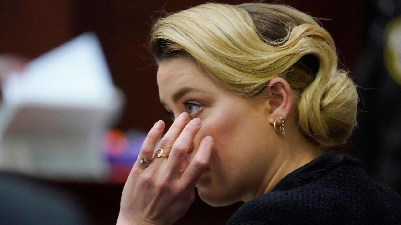 Amber Heard listens in the courtroom. (Photo by Steve Helber / POOL / AFP)