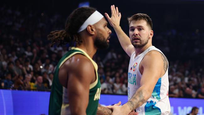 OKINAWA, JAPAN - SEPTEMBER 01: Luka Doncic #77 of Slovenia and Patty Mills #5 of Australia shakes hands during the FIBA Basketball World Cup 2nd Round Group K game between Slovenia and Australia at Okinawa Arena on September 01, 2023 in Okinawa, Japan. (Photo by Takashi Aoyama/Getty Images)